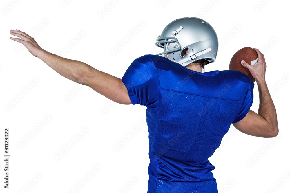 Rear view of American football player throwing ball Rear view of American football player throwing ball