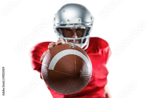 American football player in red jersey holding ball photo