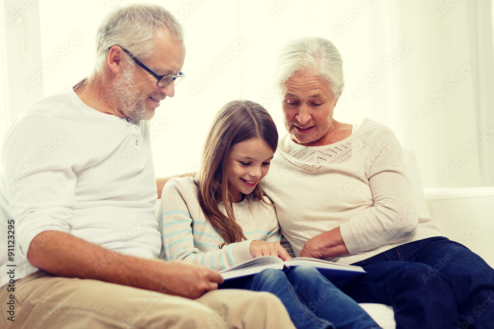 smiling family with book at home