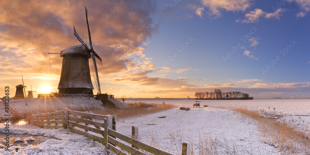 Traditional Dutch windmills in winter at sunrise - obrazy, fototapety, plakaty 