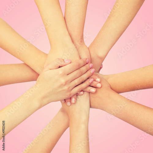 close up of women with hands on top