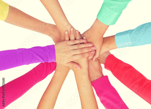 close up of women hands on top in rainbow clothes