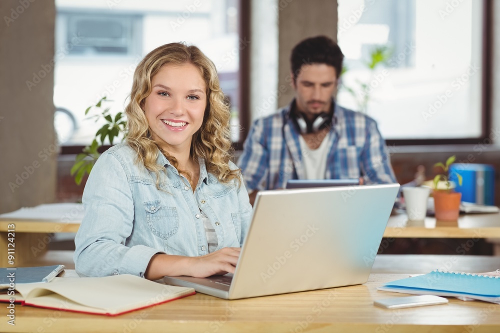 Portrait of beautiful woman with laptop in office Portrait of beautiful woman with laptop in office