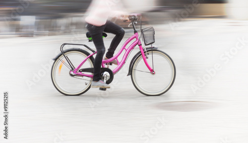 Young girl on pink bike