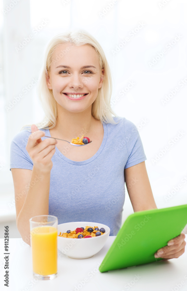 smiling woman with tablet pc eating breakfast smiling woman with tablet pc eating breakfast