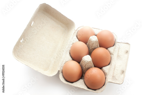 Brown eggs in packing for eggs isolated on white background