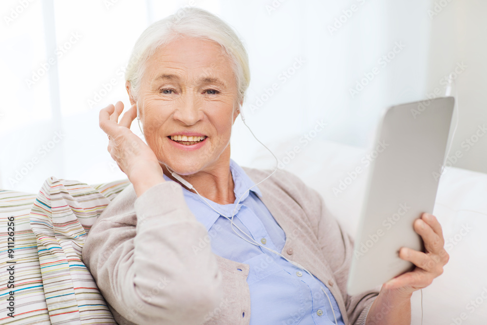 senior woman with tablet pc and earphones at home senior woman with tablet pc and earphones at home