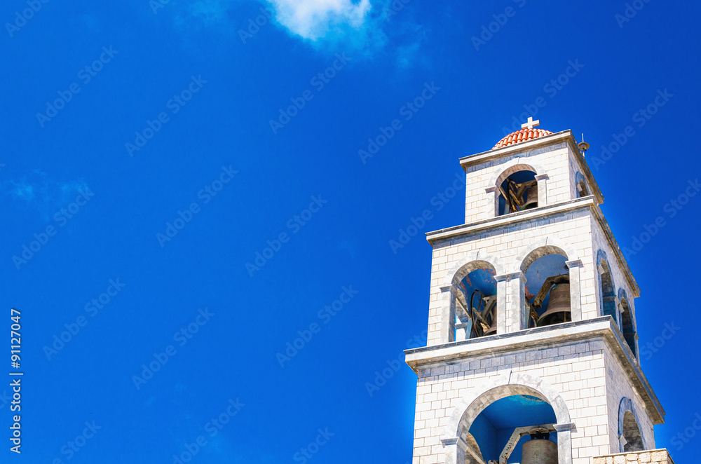 Fototapeta premium View on church tower with bell, Greece