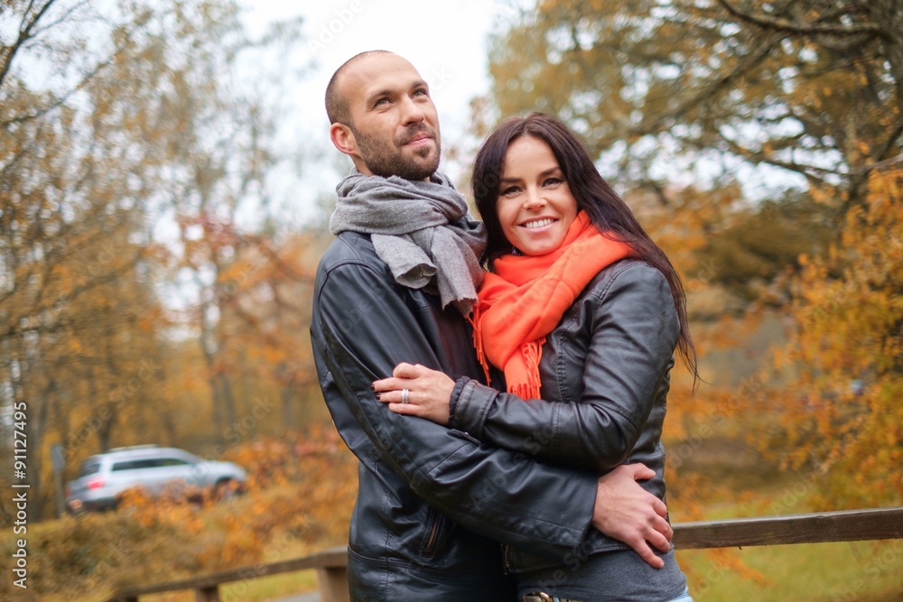 Happy middle-aged couple outdoors on beautiful autumn day Happy middle-aged couple outdoors on beautiful autumn day