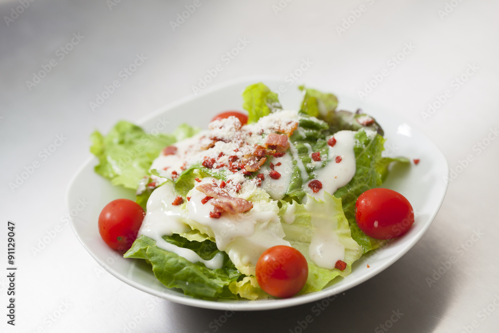 Caesar salad with white dressing served on a white bowl Caesar salad with white dressing served on a white bowl
