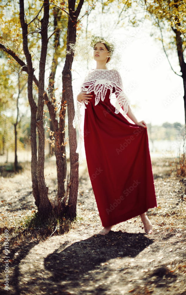 Portrait of a cute lady with red dress and , mysterious at backl