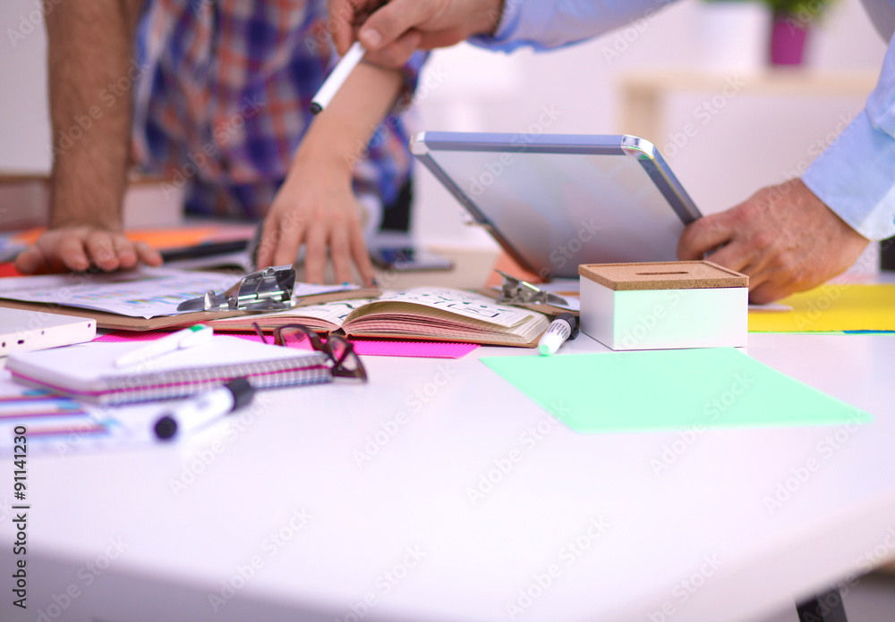 Close-up of three young creative designers working on project