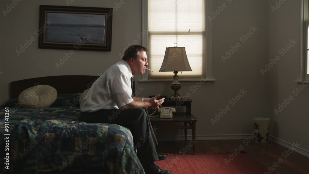 traveling businessman trying to launch a cigarette into his mouth traveling businessman trying to launch a cigarette into his mouth