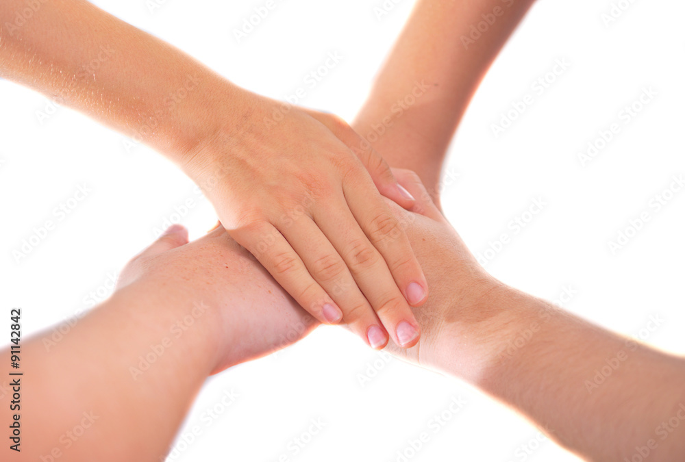 Four girl friends holding hands in a pile of unity and teamwork