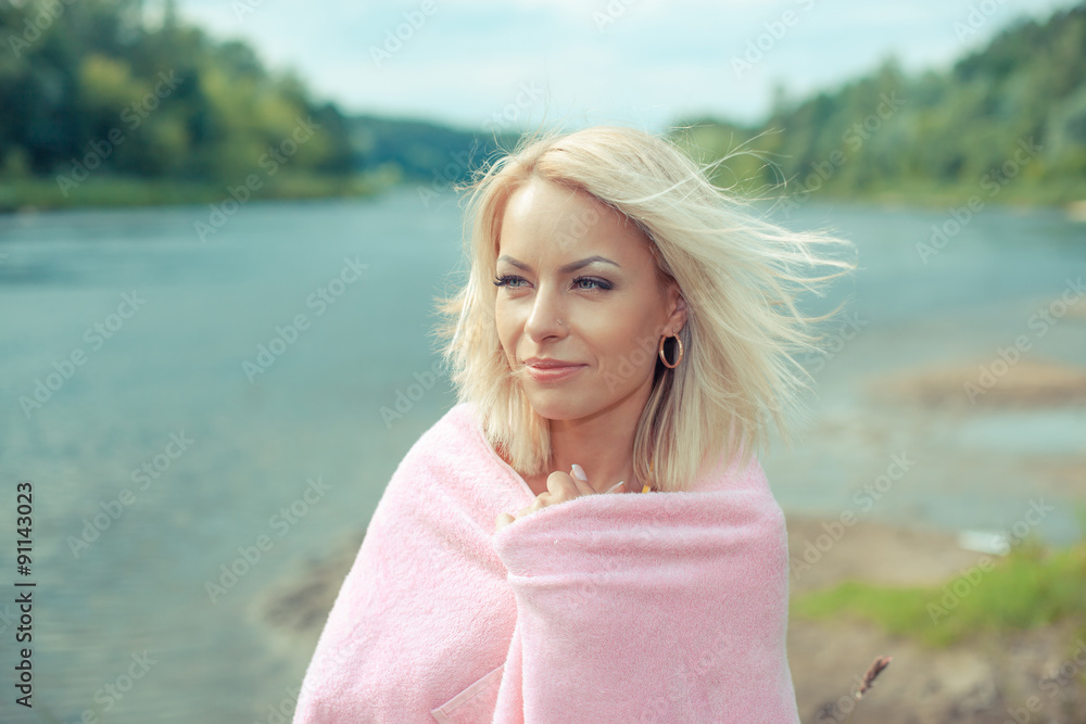 portrait of a beautiful blonde in a swimsuit, which is covered with a towel. portrait of a beautiful young girl portrait of a beautiful blonde in a swimsuit, which is covered with a towel. portrait of a beautiful young girl