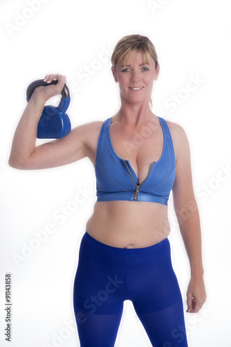 Woman exercising with a kettlebell weight in the gym