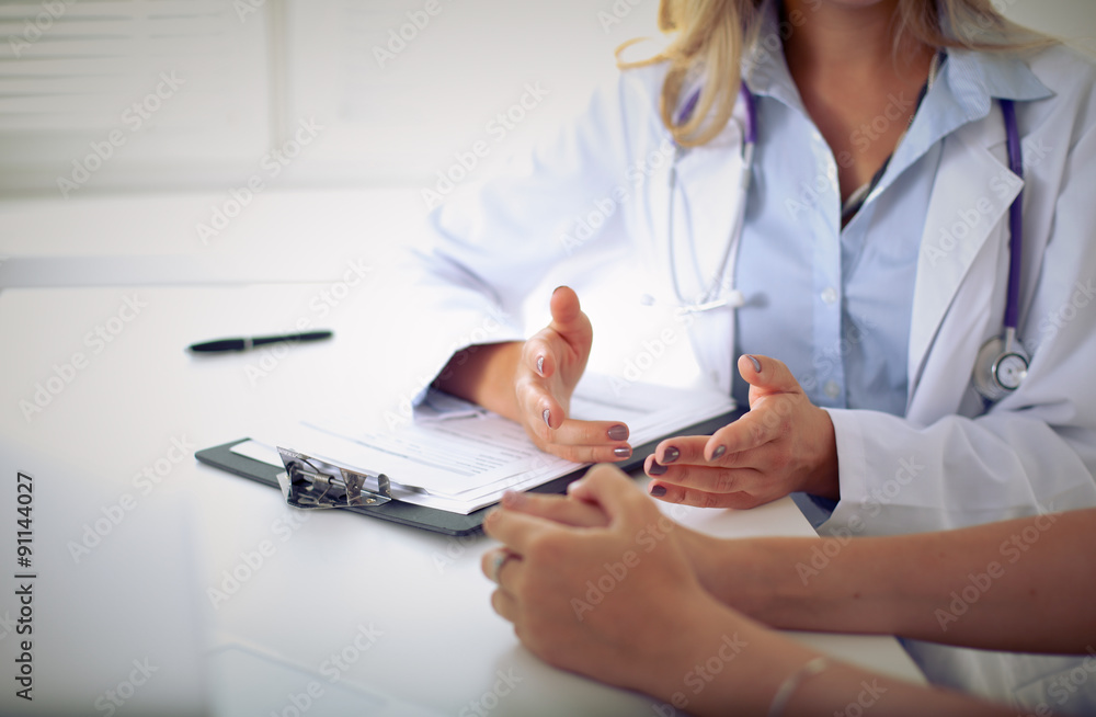 Doctor and patient are discussing something, just hands at the table Doctor and patient are discussing something, just hands at the table