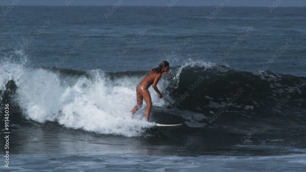 woman catching a wave on a surfboard woman catching a wave on a surfboard
