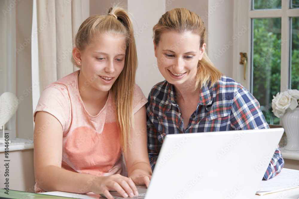 Female Home Tutor Helping Girl With Studies Using Laptop Female Home Tutor Helping Girl With Studies Using Laptop