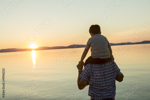 Father with is son at the sunset photo