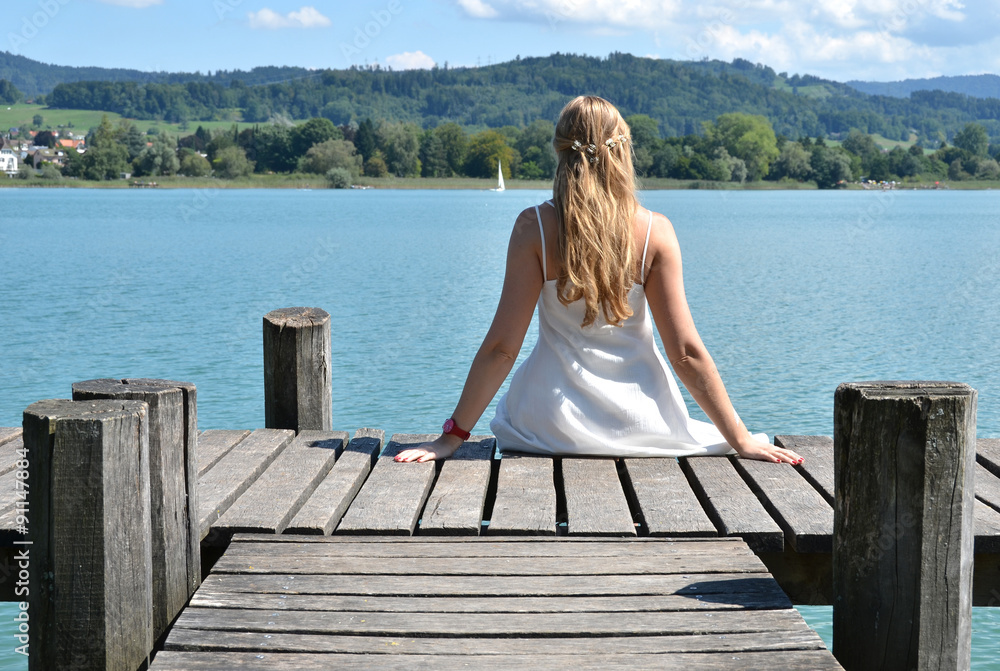 Girl on the wooden jetty. Switzerland Girl on the wooden jetty. Switzerland
