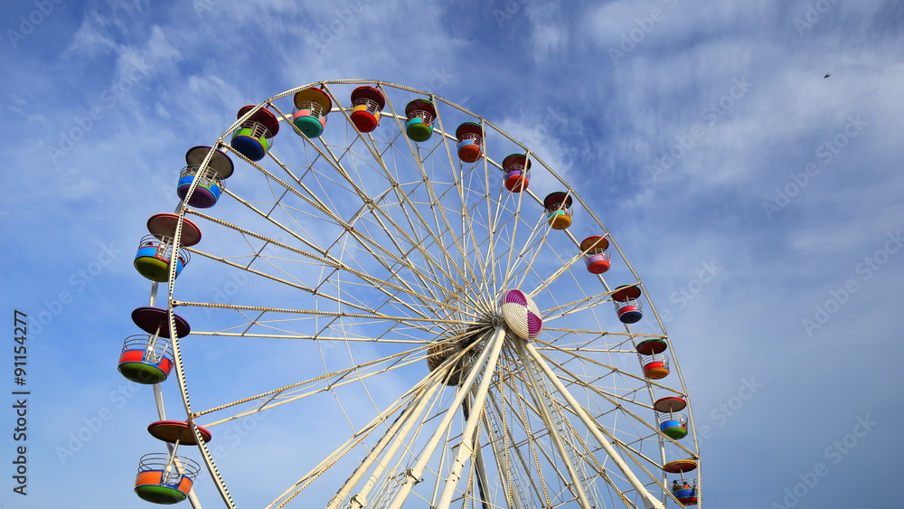 4k Time-lapse of Ferris Wheel at amusement park with blue sky background 4k Time-lapse of Ferris Wheel at amusement park with blue sky background