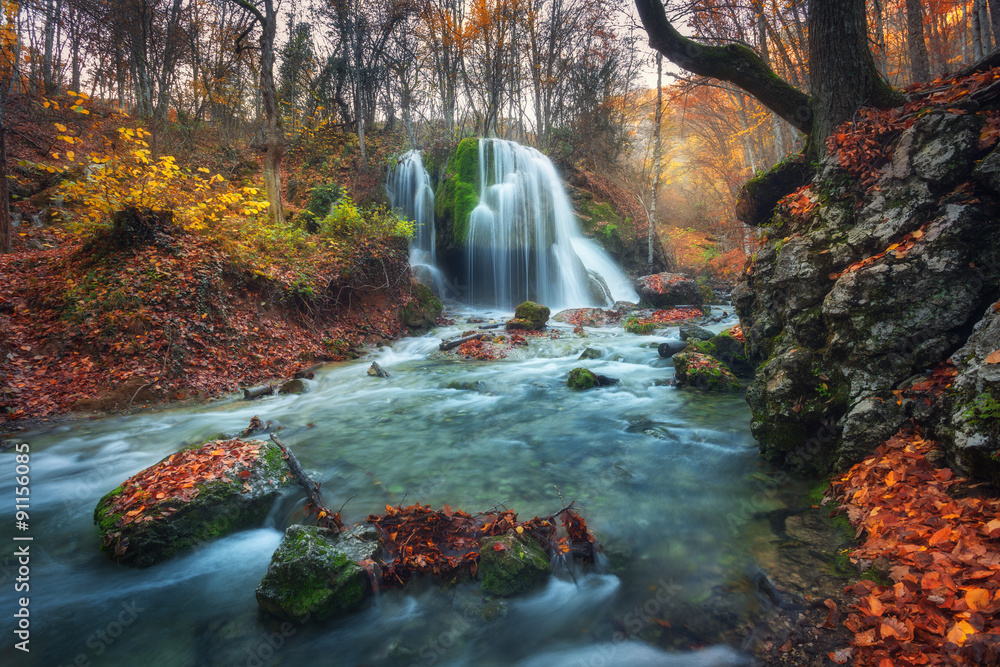 Fototapeta premium Beautiful waterfall in autumn forest in crimean mountains at sun