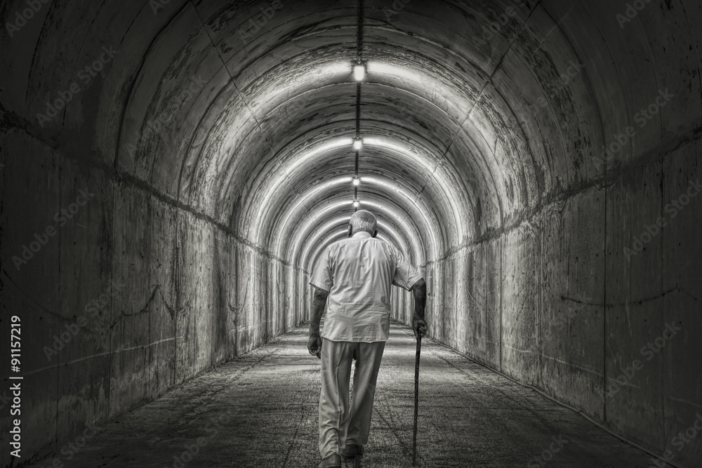 Old Man Walking through Tunnel