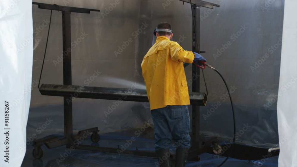 MS TD Construction worker spraying water / Orem, Utah, USA. MS TD Construction worker spraying water / Orem, Utah, USA.