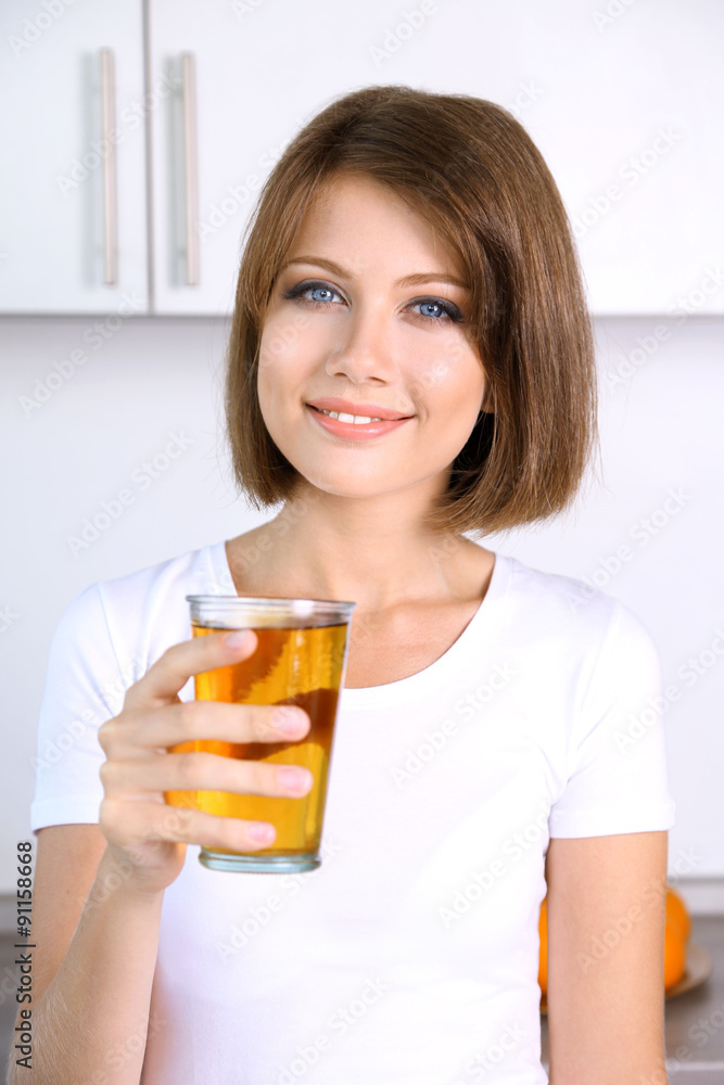 Young beautiful woman showing glass of apple juice Young beautiful woman showing glass of apple juice