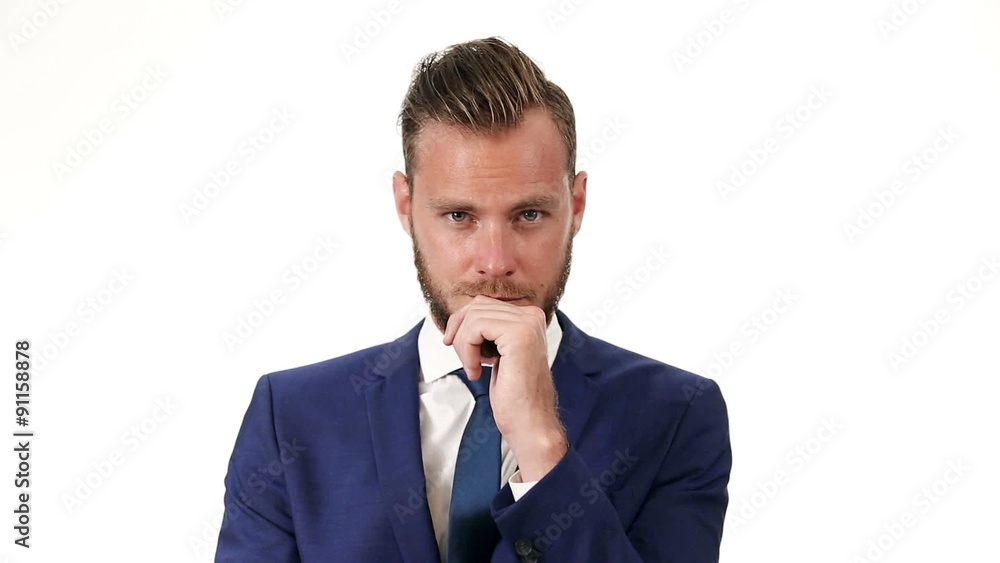 Closeup video of an attractive businessman in his 20s, wearing a blue suit and blue tie. Against a white background. Closeup video of an attractive businessman in his 20s, wearing a blue suit and blue tie. Against a white background.