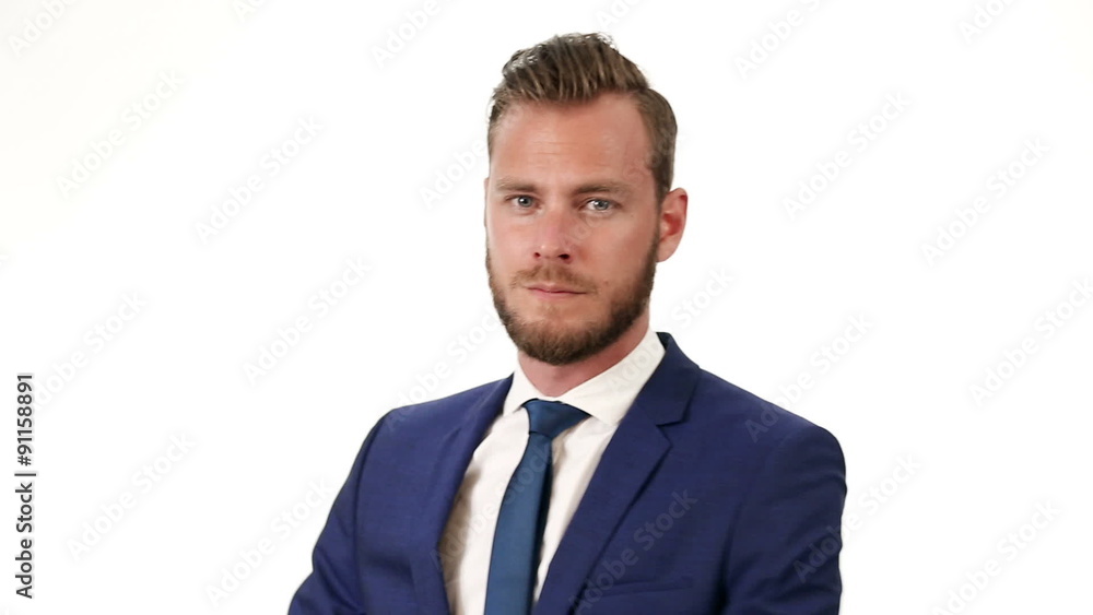 Closeup video of an attractive businessman in his 20s, wearing a blue suit and blue tie. Against a white background. Closeup video of an attractive businessman in his 20s, wearing a blue suit and blue tie. Against a white background.