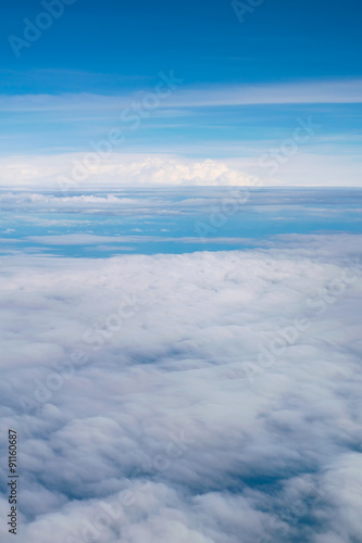Blue sky and clouds. view from the window of an airplane flying in the clouds