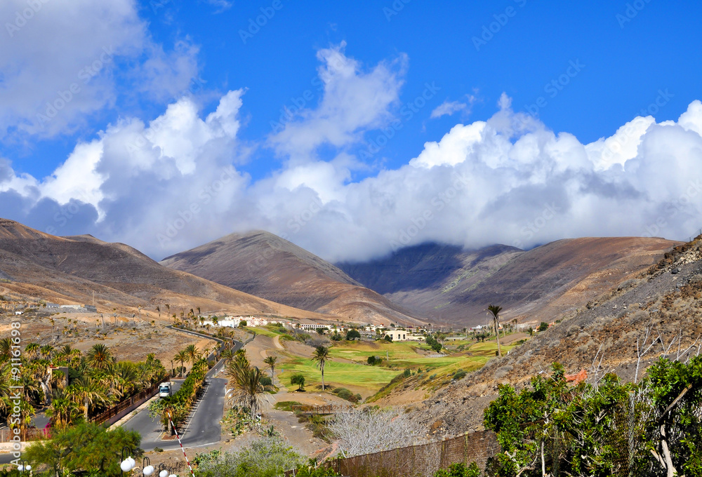 Fototapeta premium Beautiful volcanic mountains, clouds and blue sky. Fuerteventura