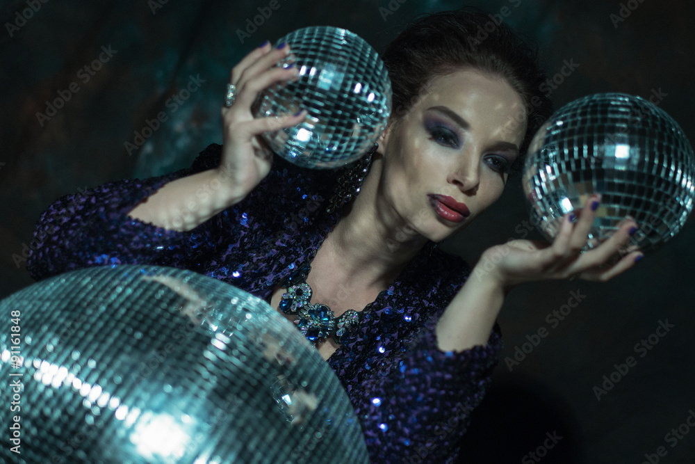 Fototapeta premium young woman holding disco ball