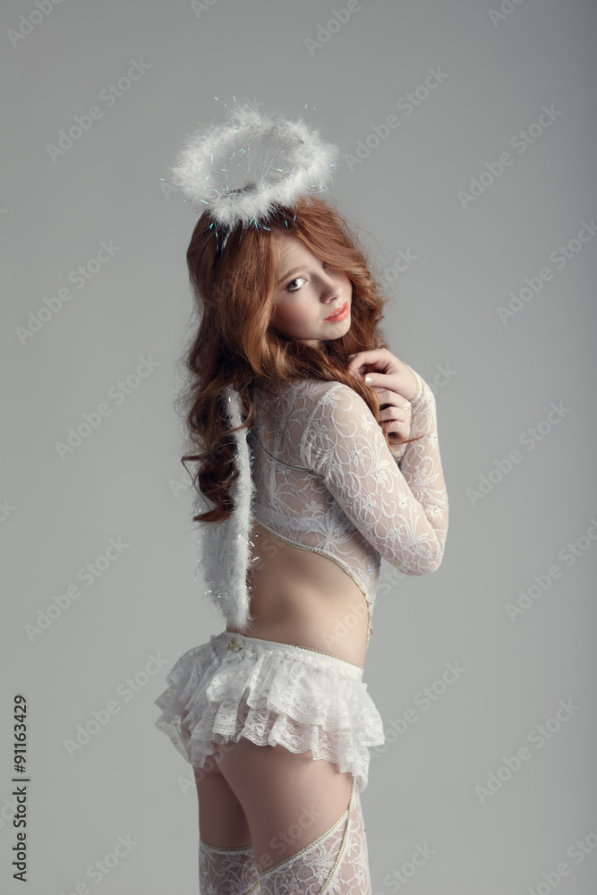 Innocence and sexuality. Girl in angel costume