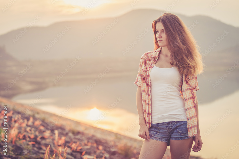 Fototapeta premium Trendy Hipster Girl Relaxing near the lake at the day time.