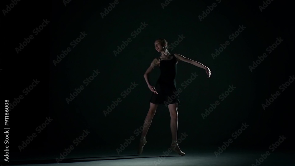 attractive ballerina in the ballet hall on black. slow motion attractive ballerina in the ballet hall on black. slow motion