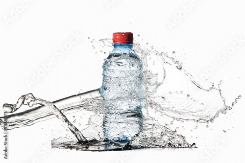 Water. Small plastic water bottle with water drops and splash on