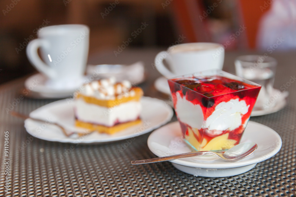 Two desserts stand on table in cafe Two desserts stand on table in cafe