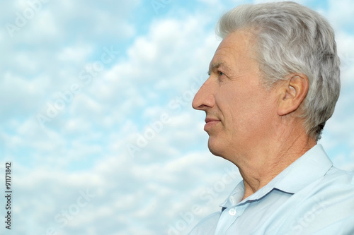 Older man on background of the sky