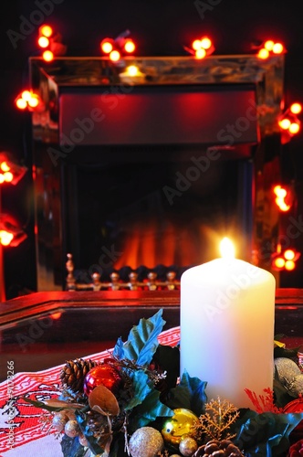 Christmas candle and fireplace. photo