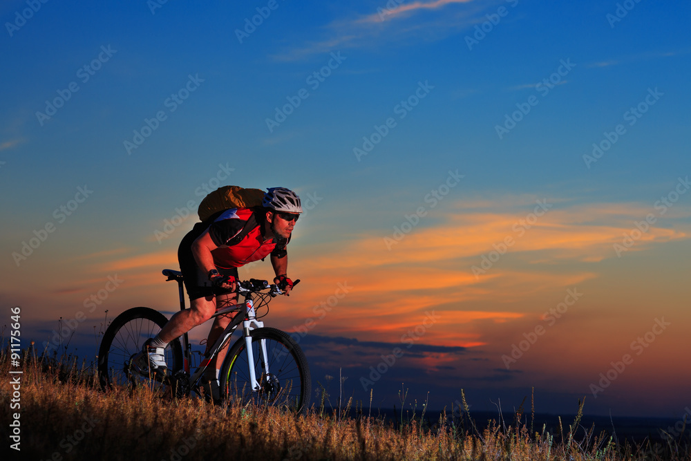Silhouette of a biker and bicycle on sunset background. Silhouette of a biker and bicycle on sunset background.