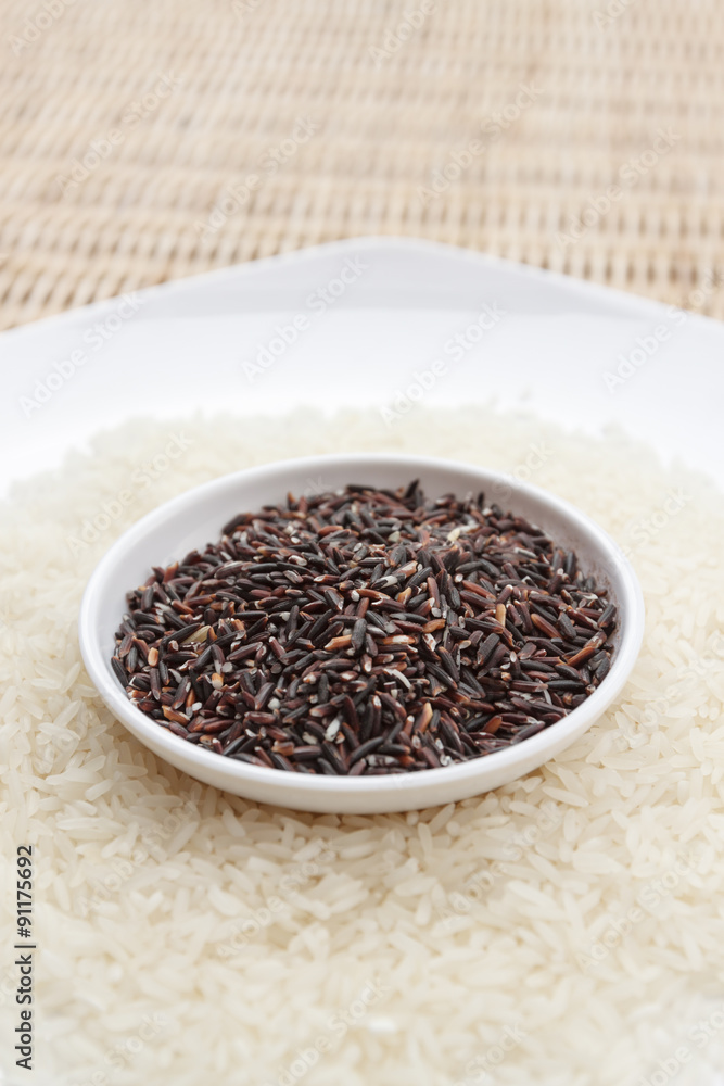 Mixture of dark brown and white rice on two white plates Mixture of dark brown and white rice on two white plates
