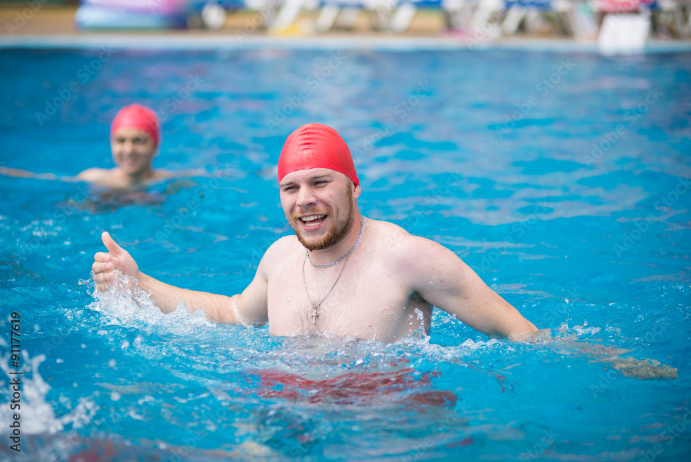 water polo. polo player in a red rubber cap in the pool. 
