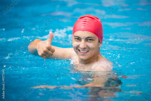 water polo. polo player in a red rubber cap in the pool.    © NatBud