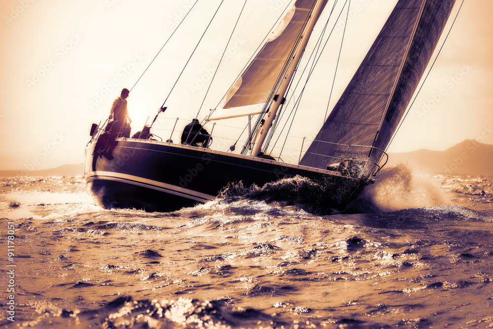Fototapeta premium sail boat sailing on sunset