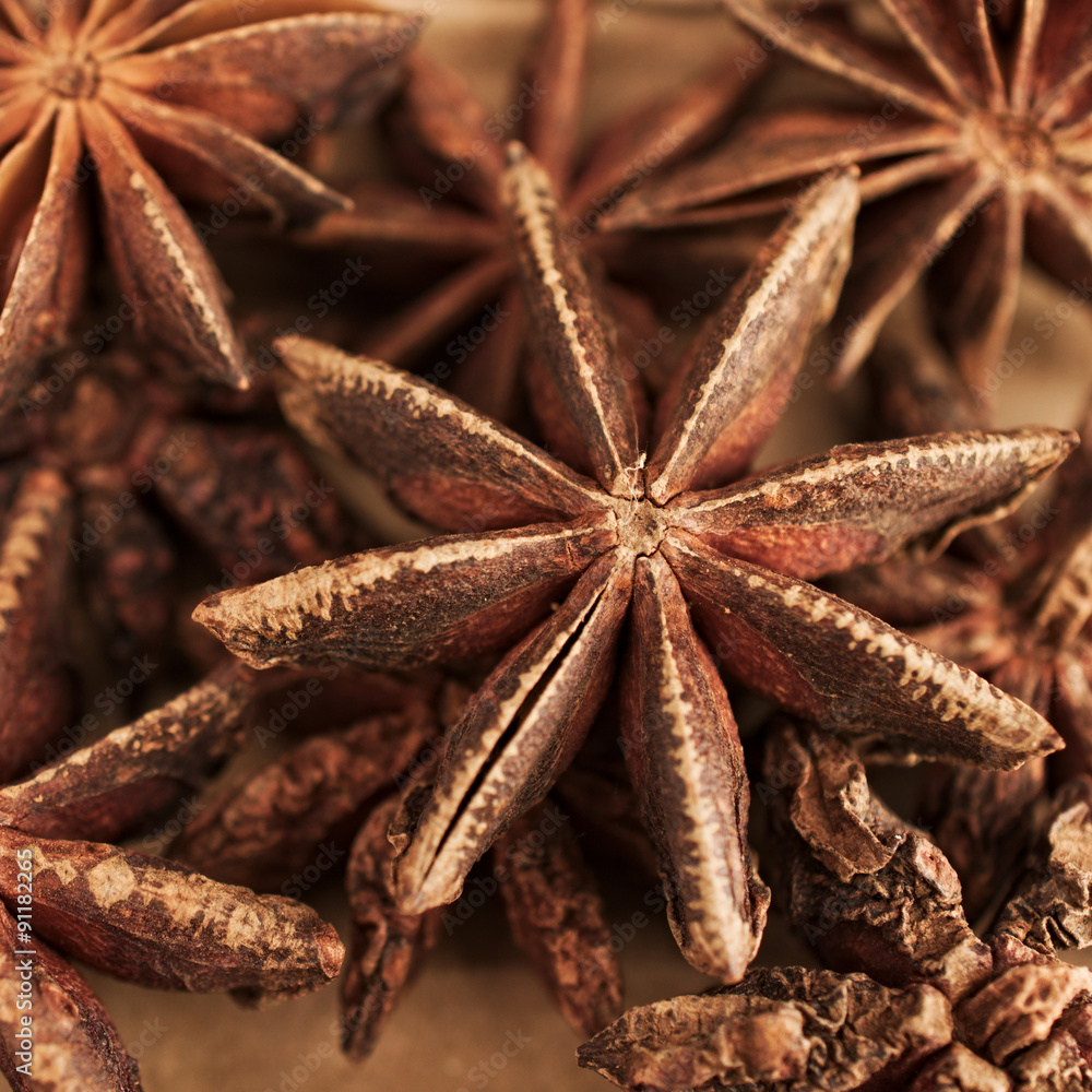 Brown star anise, asian spice against brown background Brown star anise, asian spice against brown background