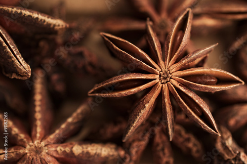 Brown star anise, asian spice against brown background