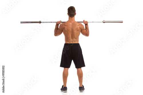 Strong Man Holding Barbell Rear View